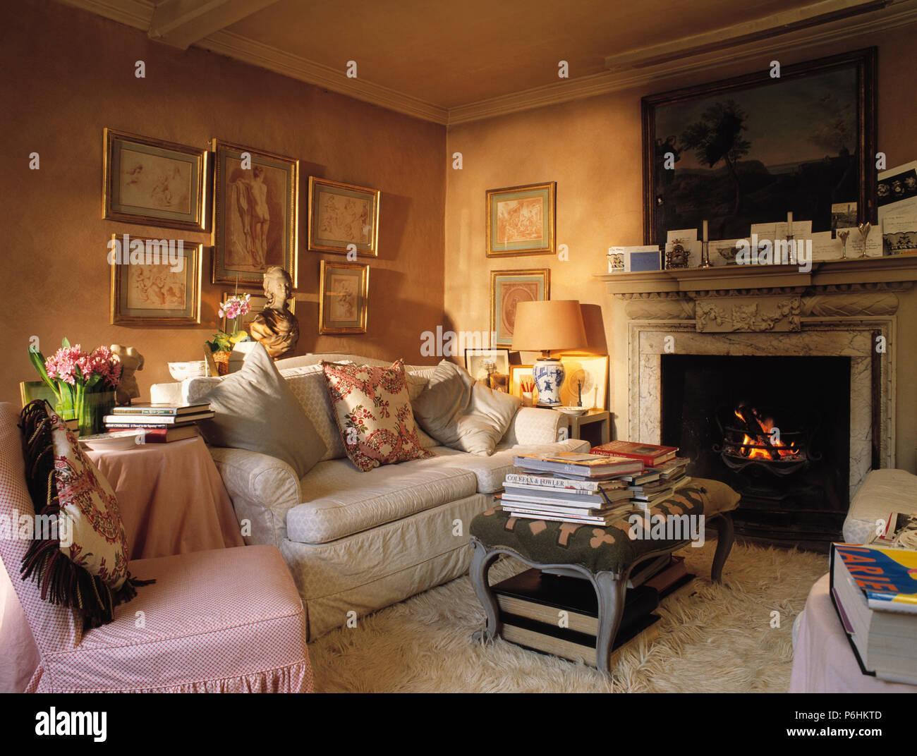 Cream Sofa And A Pink Chair In Terracotta Living Room With A