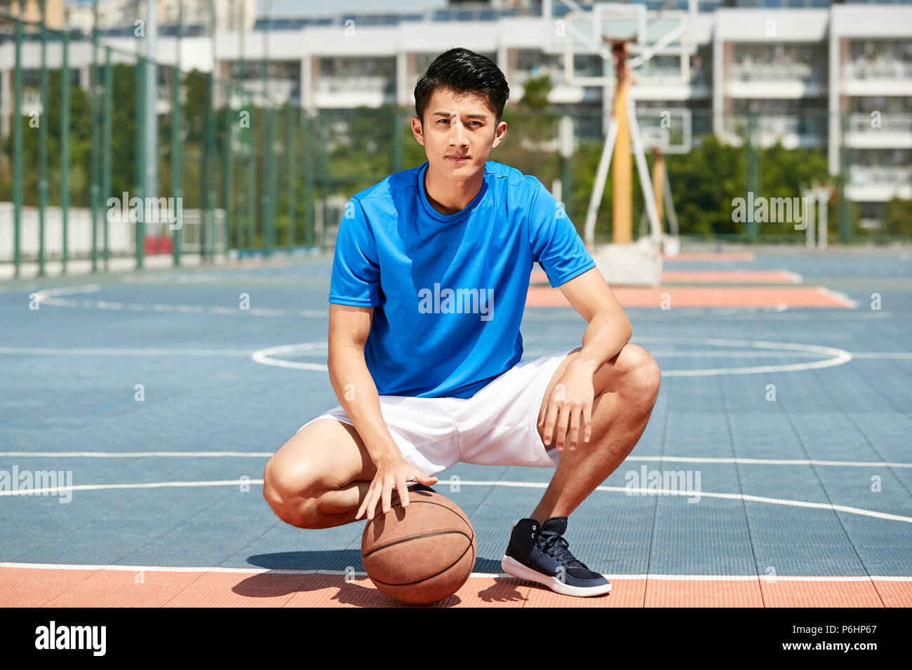 outdoor portrait of a young asian male basketball player Stock Photo