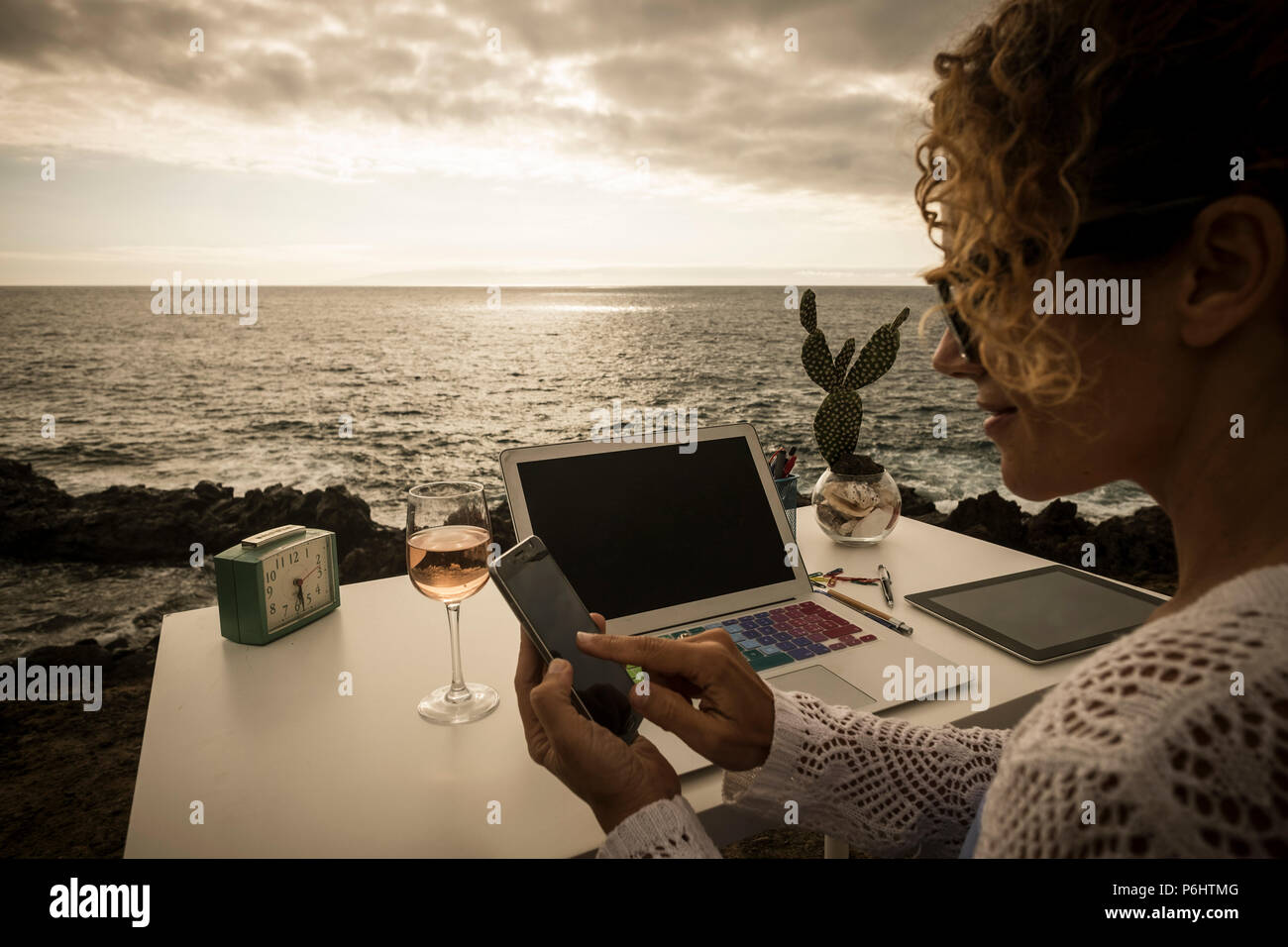 beautiful assistent professional lady at work in alternative freedom concept office in front of the ocean. enjoy a different lifestyle and work with s Stock Photo