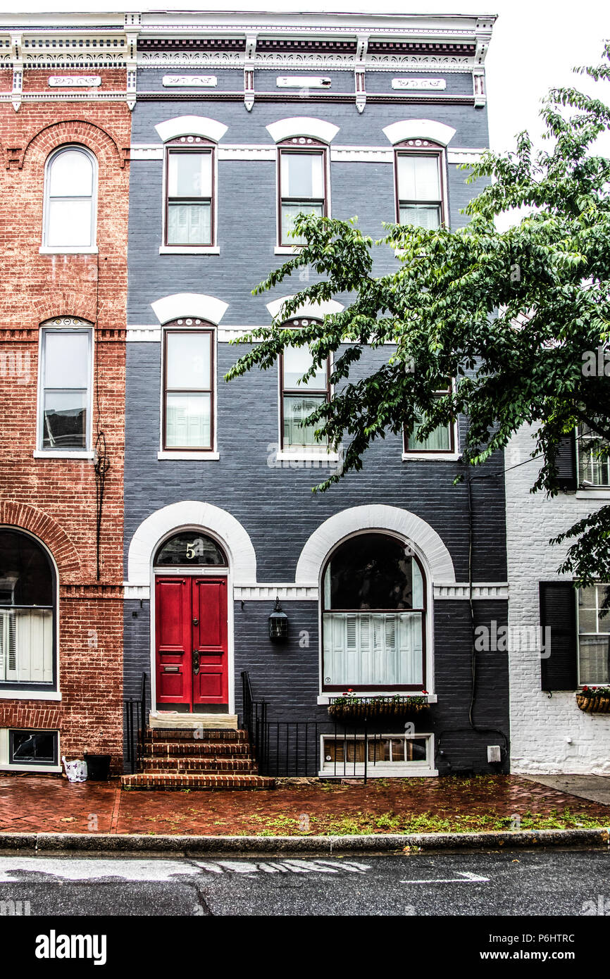 Gray Frederick Townhouse With A Red Door And White Window