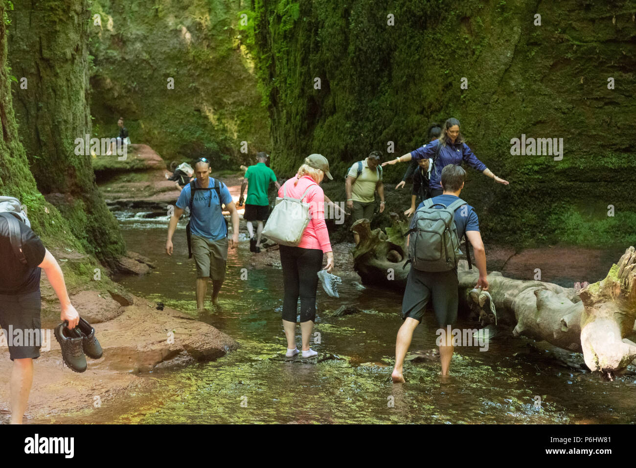 Tourists at Finnich Glen, Stirlingshire, Scotland - a beauty spot coming under increased pressure due to being used as a film location in Outlander Stock Photo