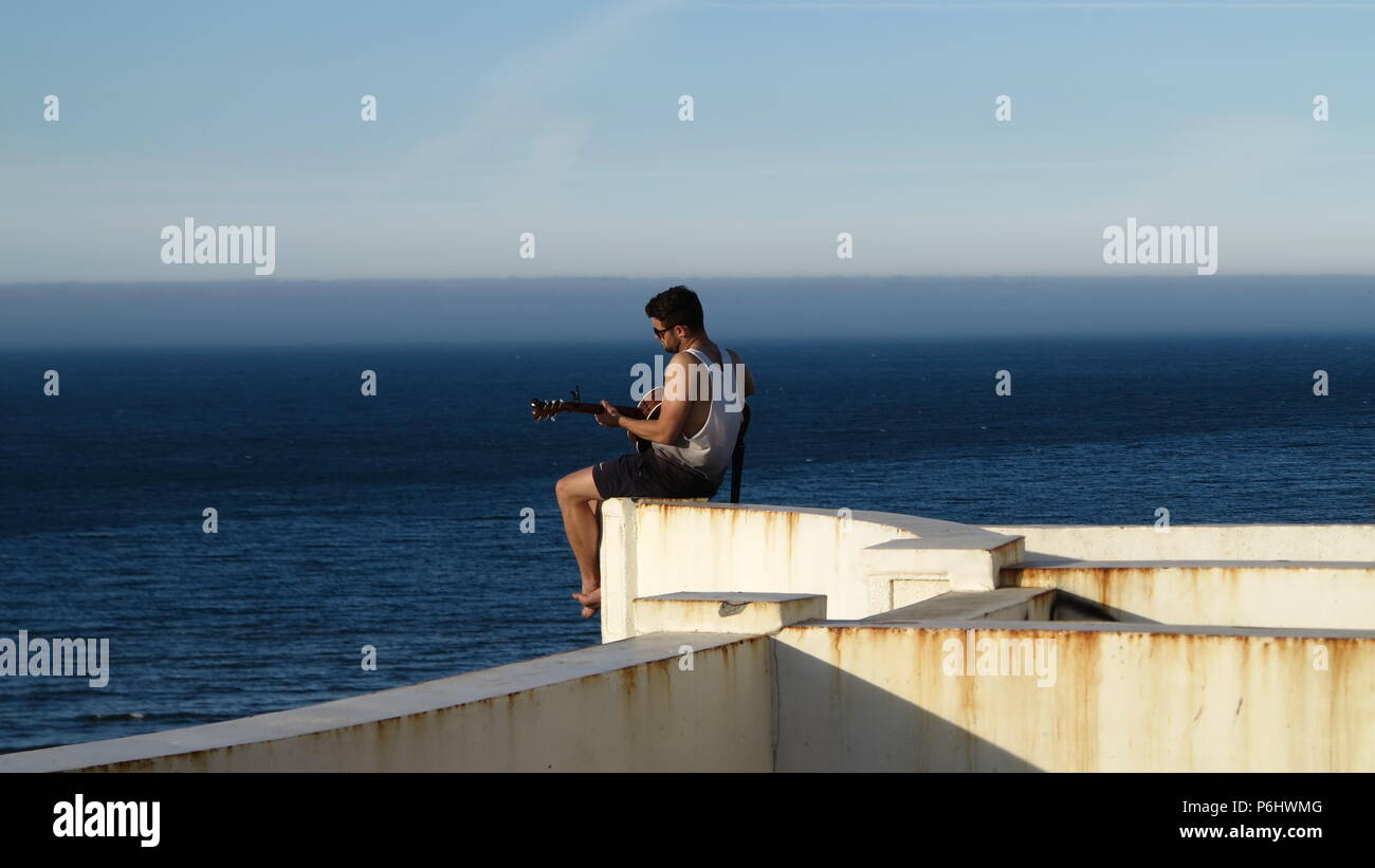 Lonely guitarist Stock Photo