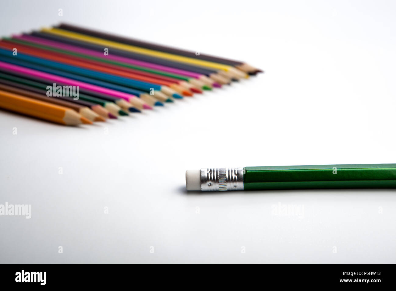 row of colored pencils and simple pencil foreground on white Stock Photo