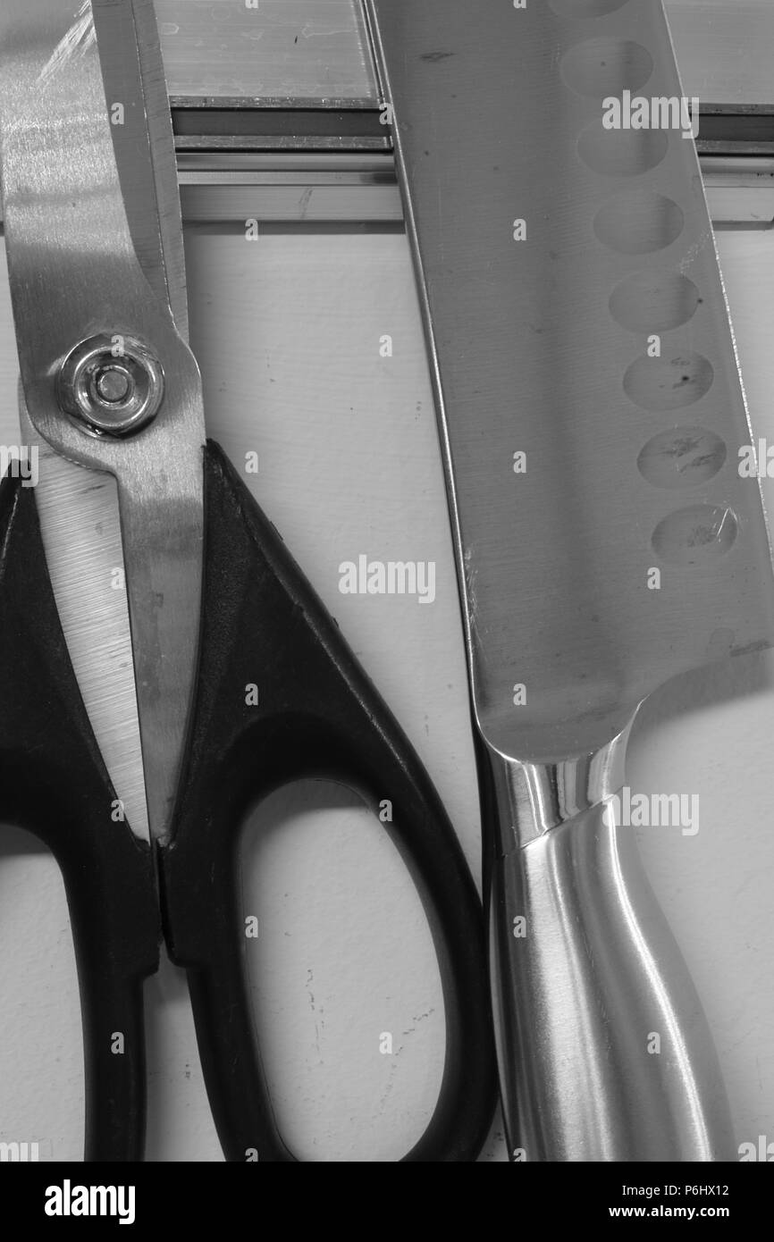 Kitchen cutlery hanging on wall Stock Photo
