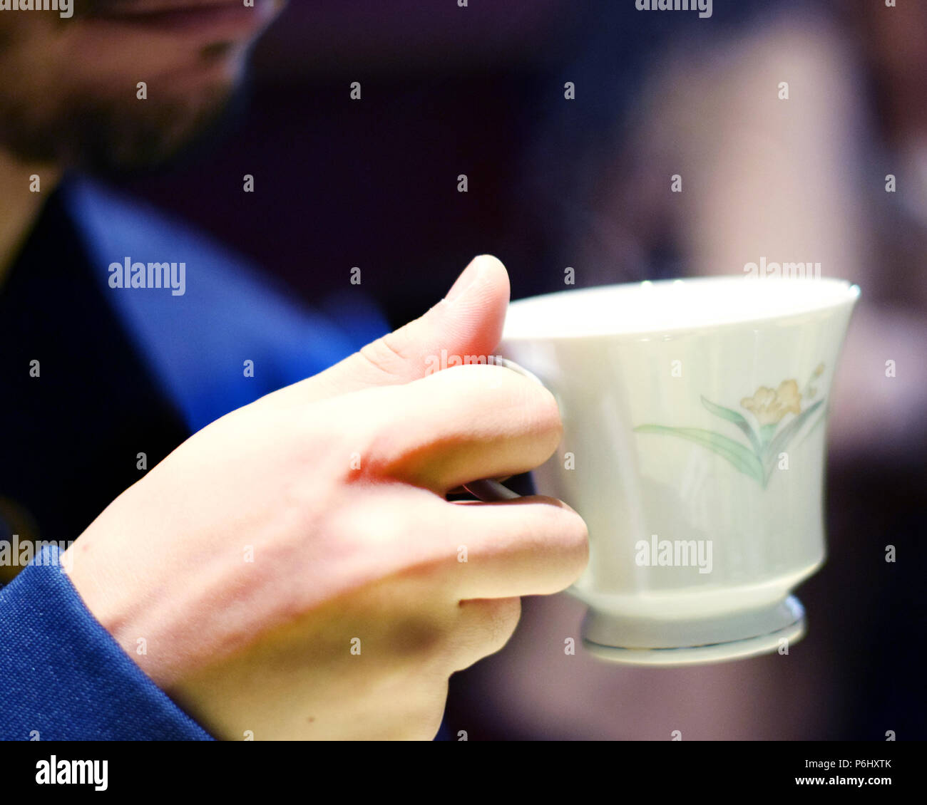 Man holding fancy steaming teacup Stock Photo Alamy