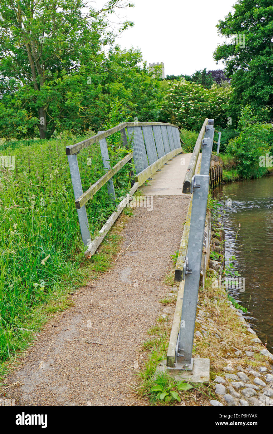 A pedestrian footbridge over the River Glaven in North Norfolk at Glandford, Norfolk, England, United Kingdom, Europe. Stock Photo