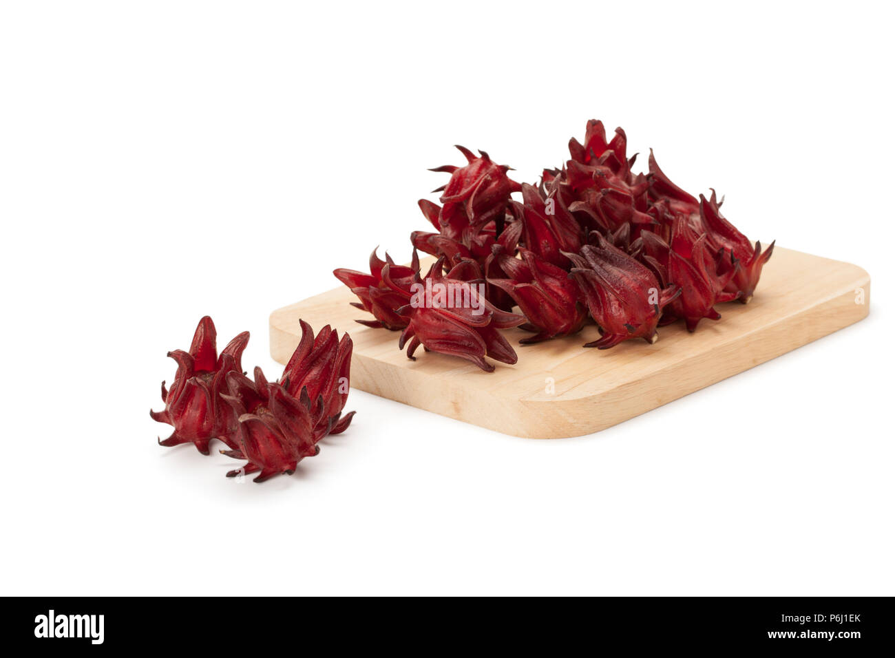 red roselle on wooden chopping board isolated on white background with clipping path and soft shadow Stock Photo