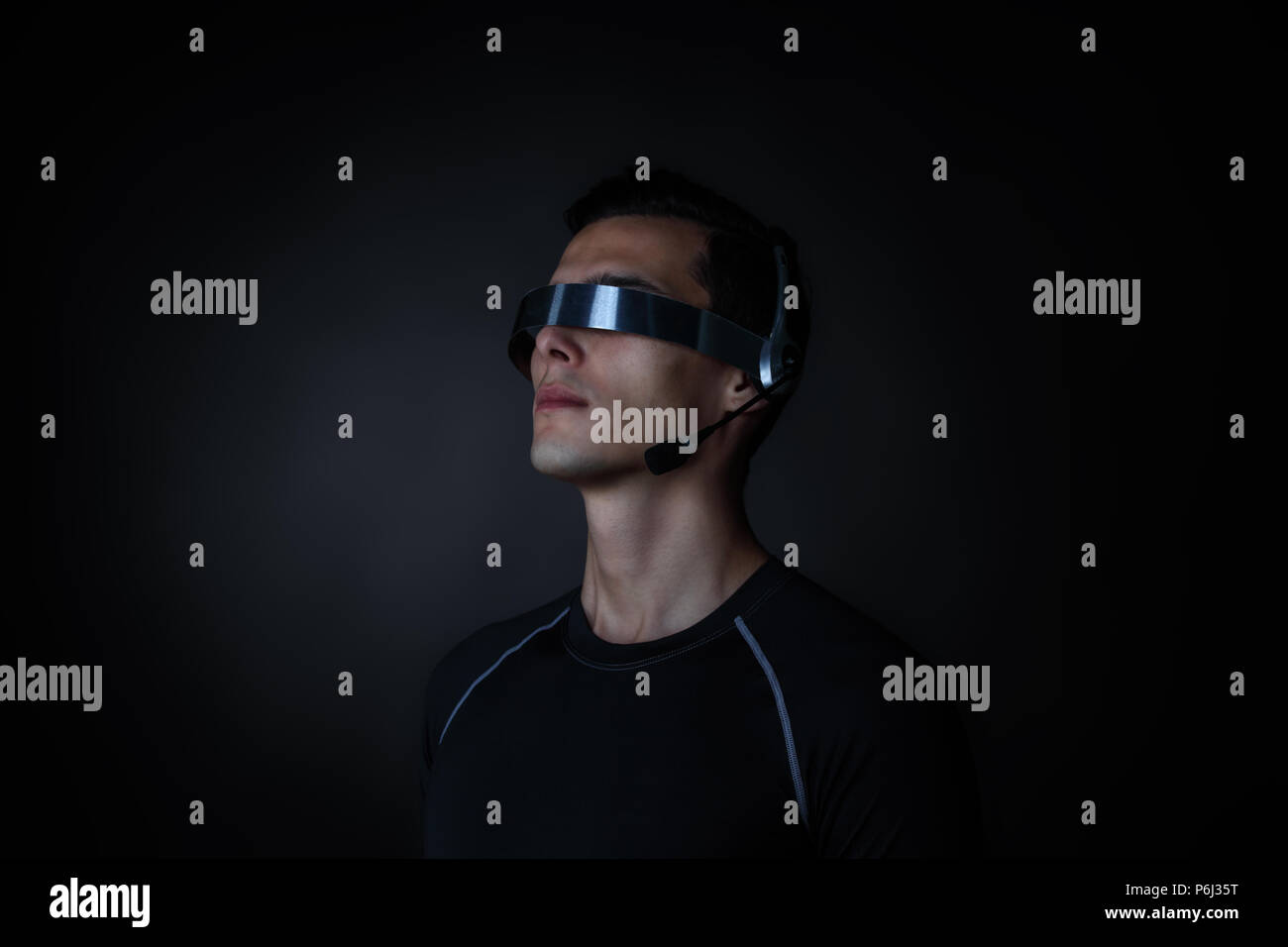 Man using futuristic VR goggles headset with microphone Stock Photo