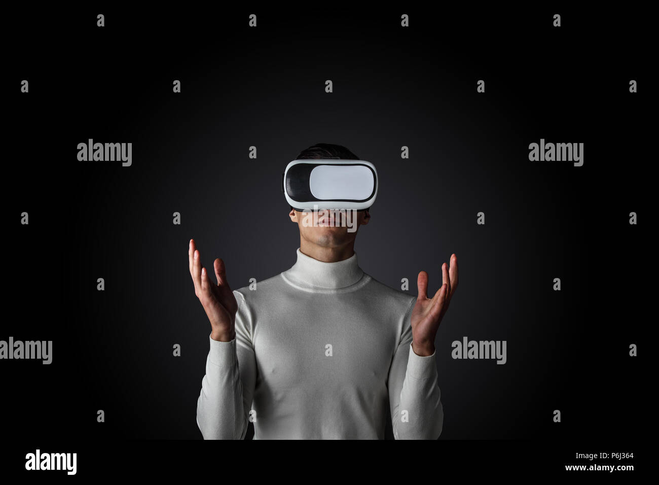Man using futuristic VR goggles and touching virtual screen with digital pen Stock Photo