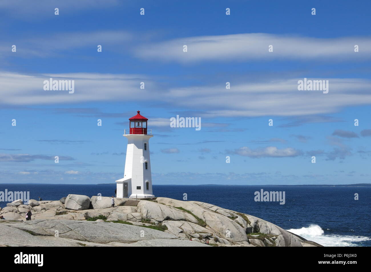The red and white lighthouse on an outcrop of granite boulders at Peggys Cove, Nova Scotia, Canada Stock Photo