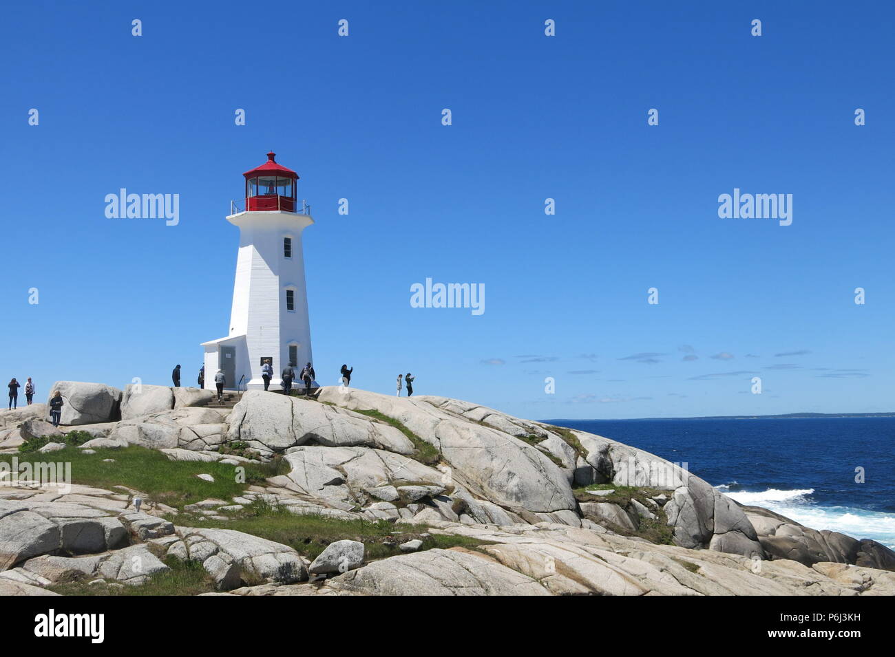 The red and white lighthouse on an outcrop of granite boulders at Peggys Cove, Nova Scotia, Canada Stock Photo