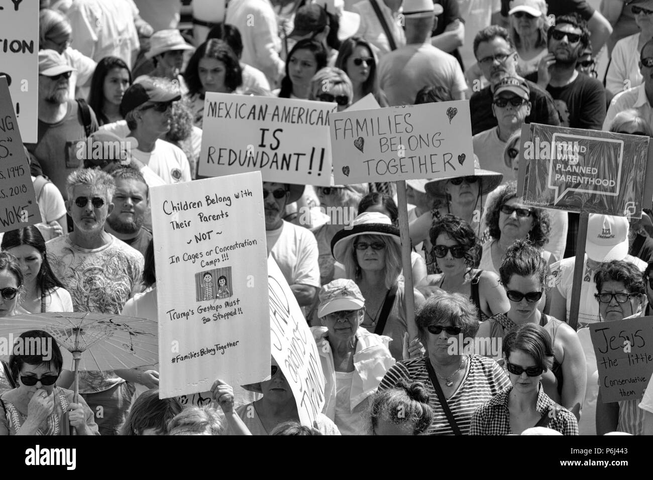 A crowd of protesters hold signs at the Families Belong Together rally in Asheville, NC, USA Stock Photo