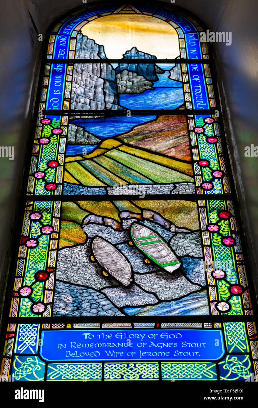 Great Britain, Shetland, Fair Isle. Church of Scotland Kirk, stained glass window. Window detail with scenic coastline and boats. Stock Photo