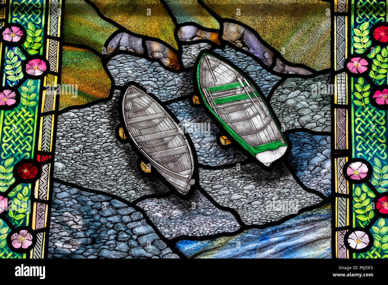 Great Britain, Shetland, Fair Isle. Church of Scotland Kirk, stained glass window. Window detail with scenic coastline and boats. Stock Photo