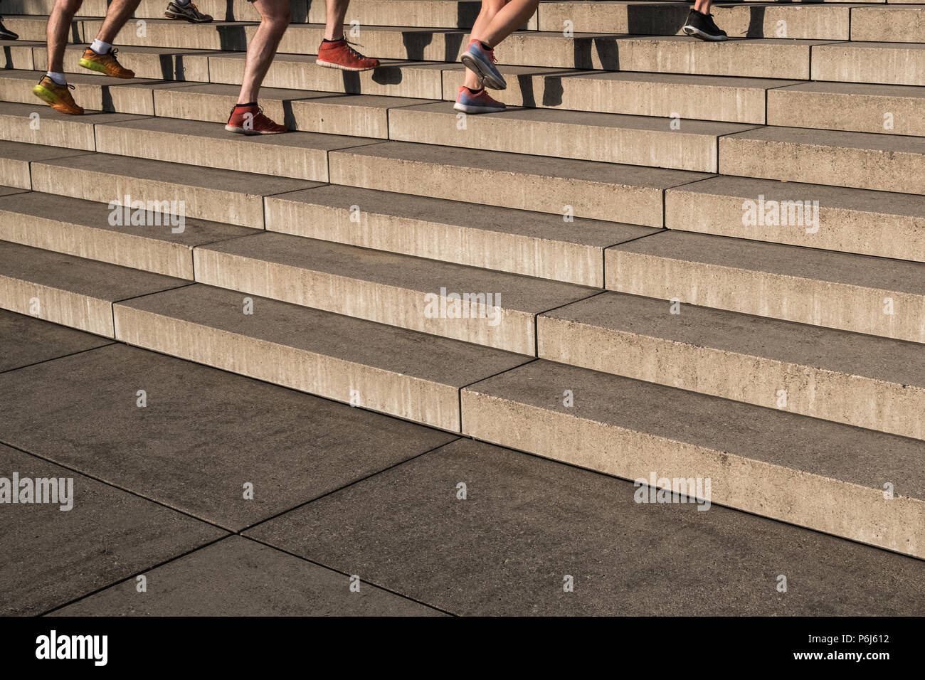 group of jogger running upwards stairs - outdoor fitness training Stock Photo