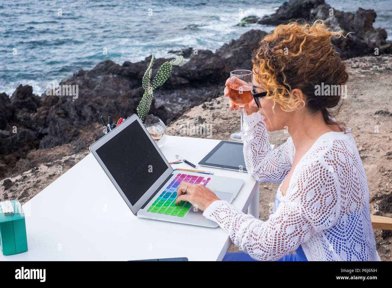Alternative office outdoor near the ocean waves to work freedom with internet connections and far away teamworks or e-commerce shop. nice beautiful la Stock Photo