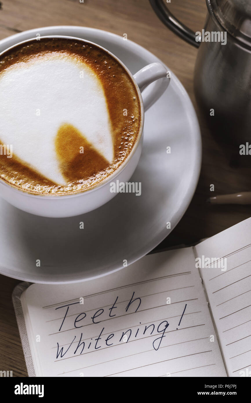 Cup of freshly prepared coffee closeup with a picture on a foam in the