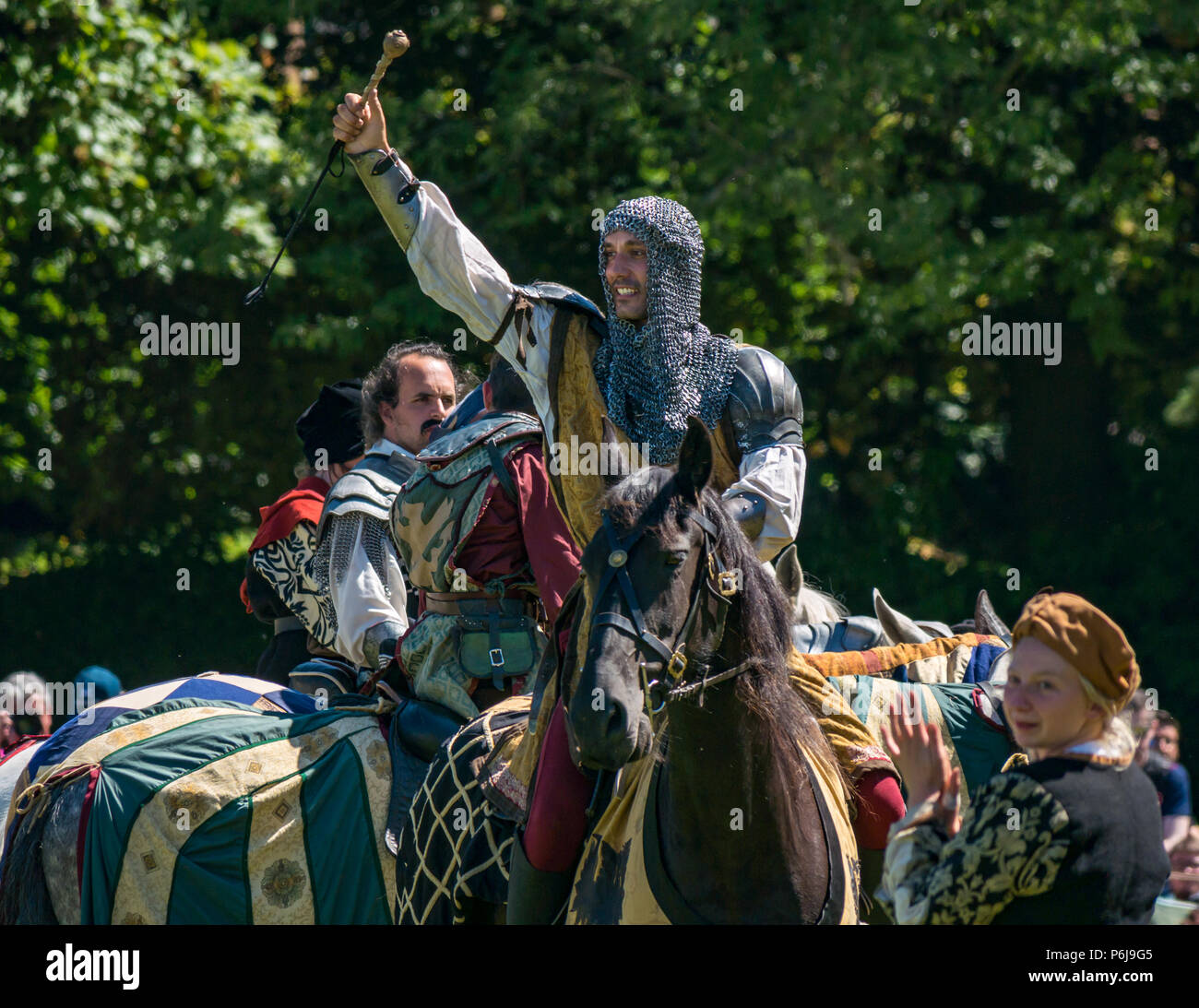 Jousting and Medieval Fair at Linlithgow Palace, Linlithgow, Scotland, United Kingdom, 30th June 2018. Historic Environment Scotland kick off their summer entertainment programme with a fabulous display of Medieval jousting in the grounds of the historic castle. The jousting is performed by Les Amis D'Onno equine stunt team. A knight holds up the lucky favour he won Stock Photo