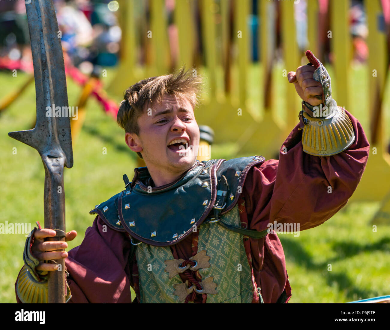 Jousting and Medieval Fair at Linlithgow Palace, Linlithgow, Scotland, United Kingdom, 30th June 2018. Historic Environment Scotland kick off their summer entertainment programme with a fabulous display of Medieval jousting in the grounds of the historic castle. The jousting is performed by Les Amis D'Onno equine stunt team. A knight cheers on the crowd with his sword raised Stock Photo