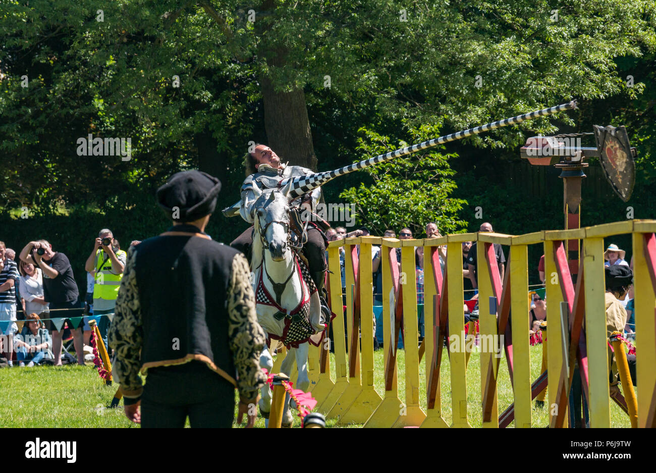 Jousting and Medieval Fair at Linlithgow Palace, Linlithgow, Scotland, United Kingdom, 30th June 2018. Historic Environment Scotland kick off their summer entertainment programme with a fabulous display of Medieval jousting in the grounds of the historic castle. The jousting is performed by Les Amis D'Onno equine stunt team. A performer riding a white horse with a lance Stock Photo