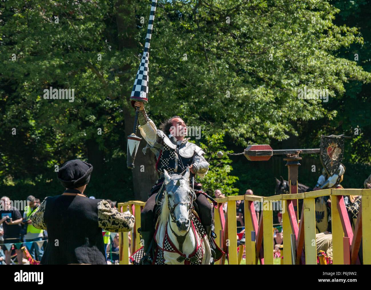 Jousting and Medieval Fair at Linlithgow Palace, Linlithgow, Scotland, United Kingdom, 30th June 2018. Historic Environment Scotland kick off their summer entertainment programme with a fabulous display of Medieval jousting in the grounds of the historic castle. The family fun day includes jousting performed by Les Amis D'Onno equine stunt team. A knight raises his lance in victory Stock Photo