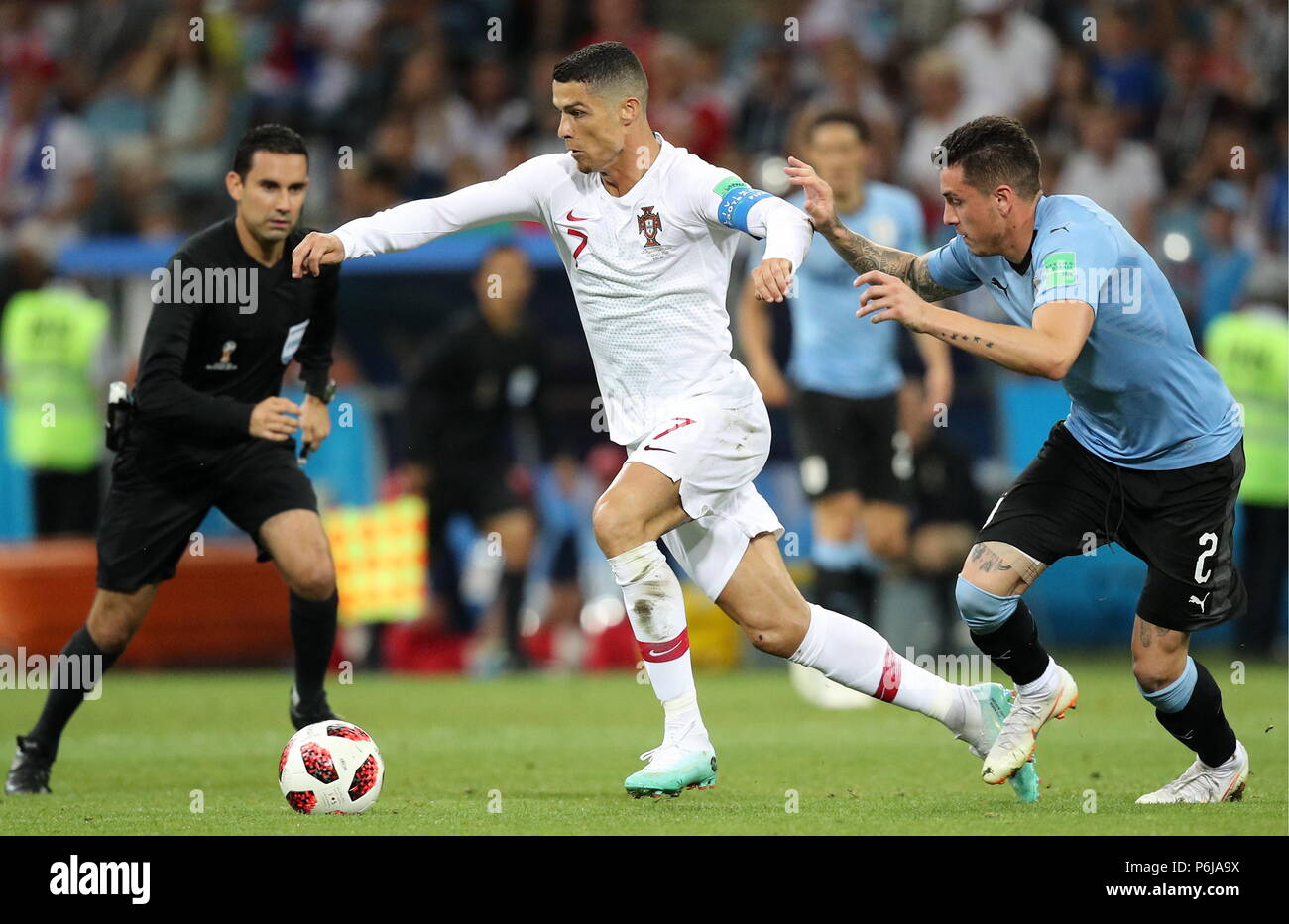 Sochi, Russia. 30th June, 2018. Portugal's Cristiano Ronaldo (C) and  Uruguay's Jose Gimenez (R) fight for the ball in their 2018 FIFA World Cup  Round of 16 match at Fisht Stadium. Sergei