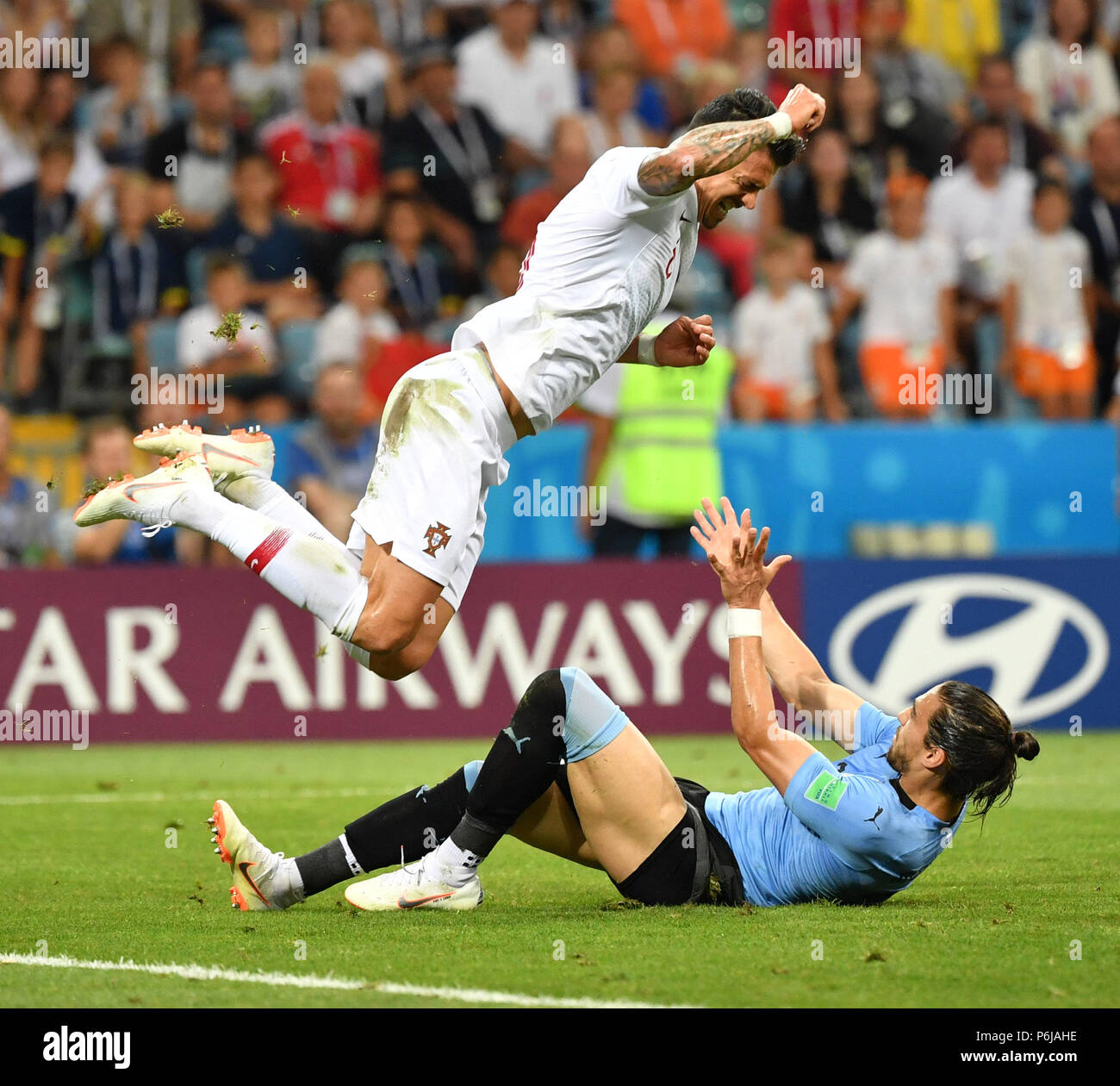 Sochi, Russia. 30th June, 2018. Jose Fonte (top) of Portugal vies with Martin Caceres of Uruguay during the 2018 FIFA World Cup round of 16 match between Uruguay and Portugal in Sochi, Russia, on June 30, 2018. Credit: Liu Dawei/Xinhua/Alamy Live News Stock Photo