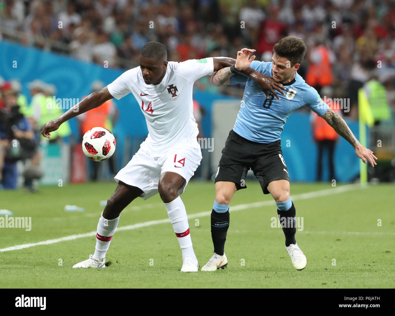 Sochi, Russia. 30th June, 2018. William Carvalho (L) of Portugal vies with Nahitan Nandez of Uruguay during the 2018 FIFA World Cup round of 16 match between Uruguay and Portugal in Sochi, Russia, June 30, 2018. Credit: Ye Pingfan/Xinhua/Alamy Live News Stock Photo