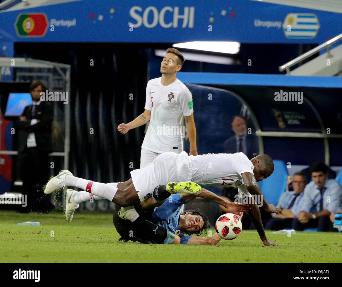 Sochi, Russia. 30th June, 2018. Fußball: Football World Cup, Uruguay vs Portugal at the Fisht Stadium. Edinson Cavani of Uruguay (bottom) and William Carvalho of Portugal vie for the ball, with Raphael Guerreiro of Portugal behind. Credit: Christian Charisius/dpa/Alamy Live News Stock Photo