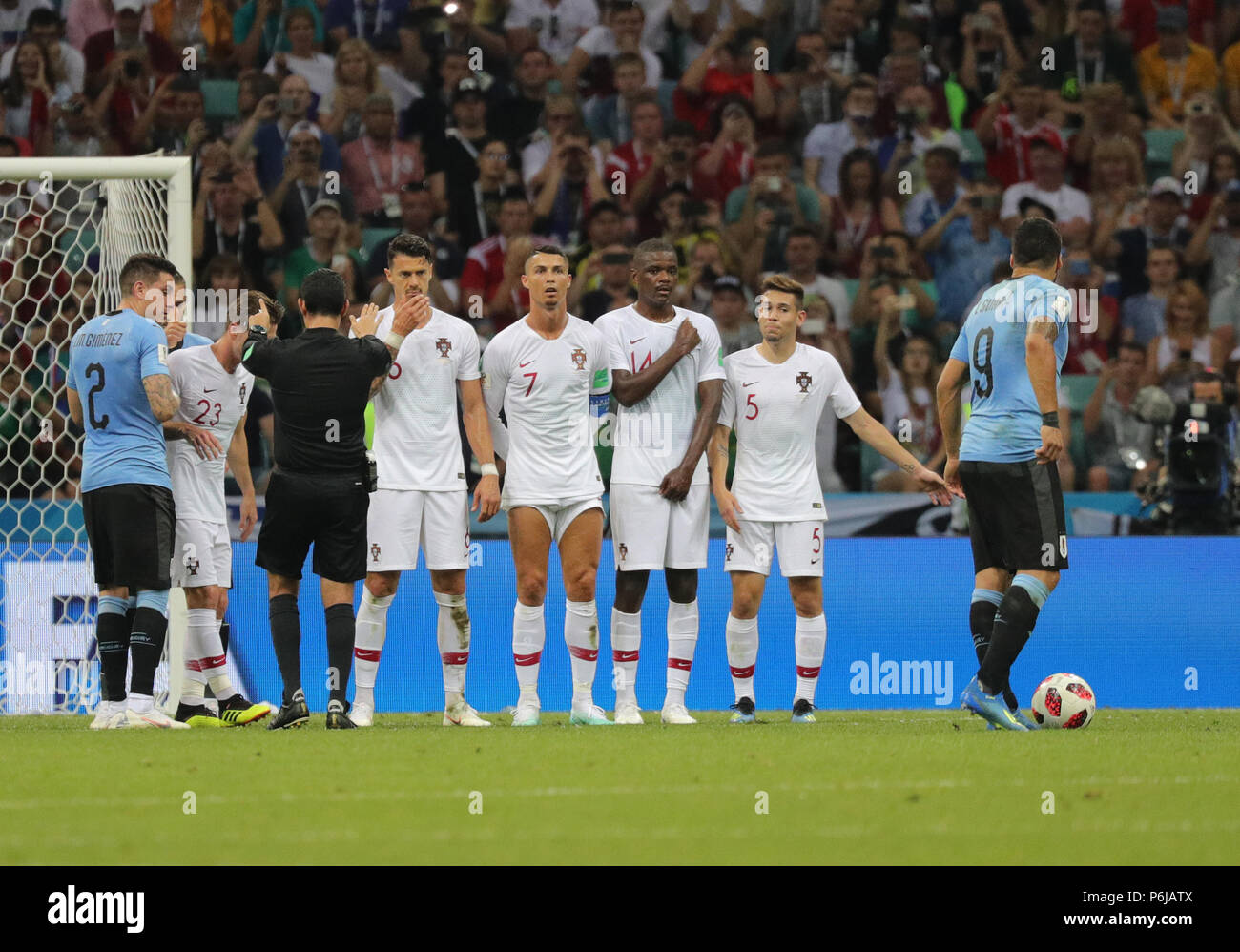 Sochi, Russia. 30th June, 2018. Fußball: Football World Cup, Uruguay vs Portugal at the Fisht Stadium. Luis Suarez (r) of Uruguay taking a freekick, in front of (r-l) Raphael Guerreiro of Portugal, William Carvalho of Portugal, Cristiano Ronaldo of Portugal, Jose Fonte of Portugal. Credit: Christian Charisius/dpa/Alamy Live News Stock Photo