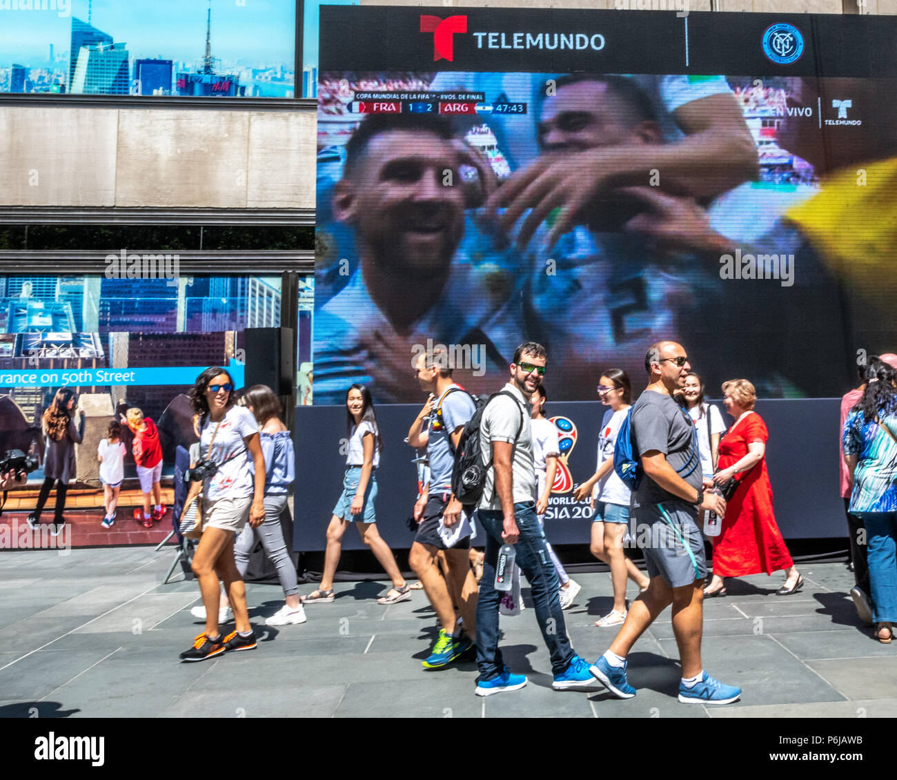 New York, USA, 30 June 2018.  Passers.-by don't pay much attention to Argentina's player Lionel Messi celebrating a goal  against France at the FIFA World Cup in giant screens at New York City's Rockefeller Center. France beat Argentina 4-3 to advance to the quarter finals.  Photo by Enrique ShoreCredit: Enrique Shore/Alamy Live News Stock Photo