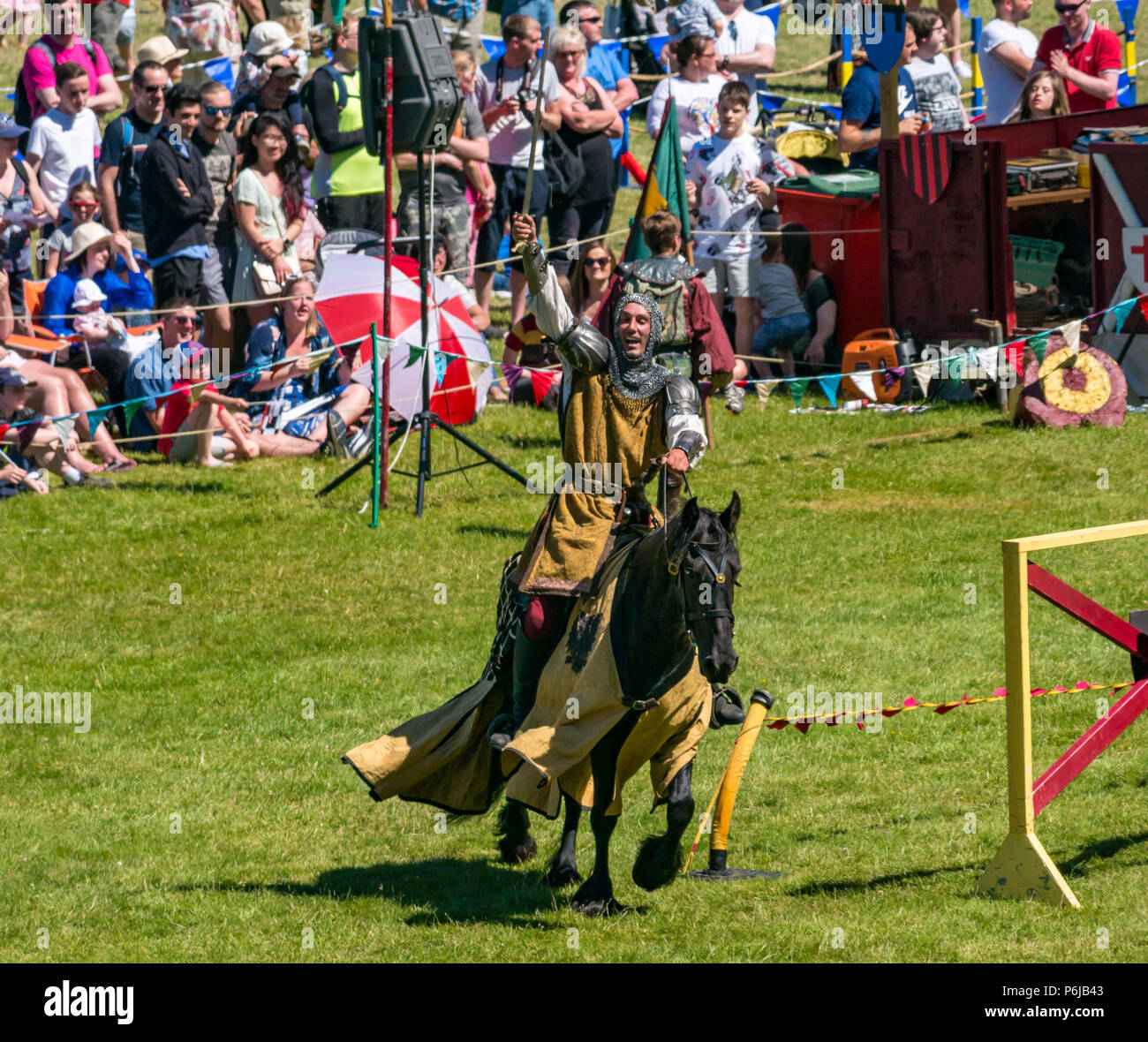 Jousting and Medieval Fair at Linlithgow Palace, Linlithgow, Scotland, United Kingdom, 30th June 2018. Historic Environment Scotland kick off their summer entertainment programme with a fabulous display of Medieval jousting in the grounds of the historic castle. The jousting is performed by Les Amis D'Onno equine stunt team. A knight rides a horse Stock Photo