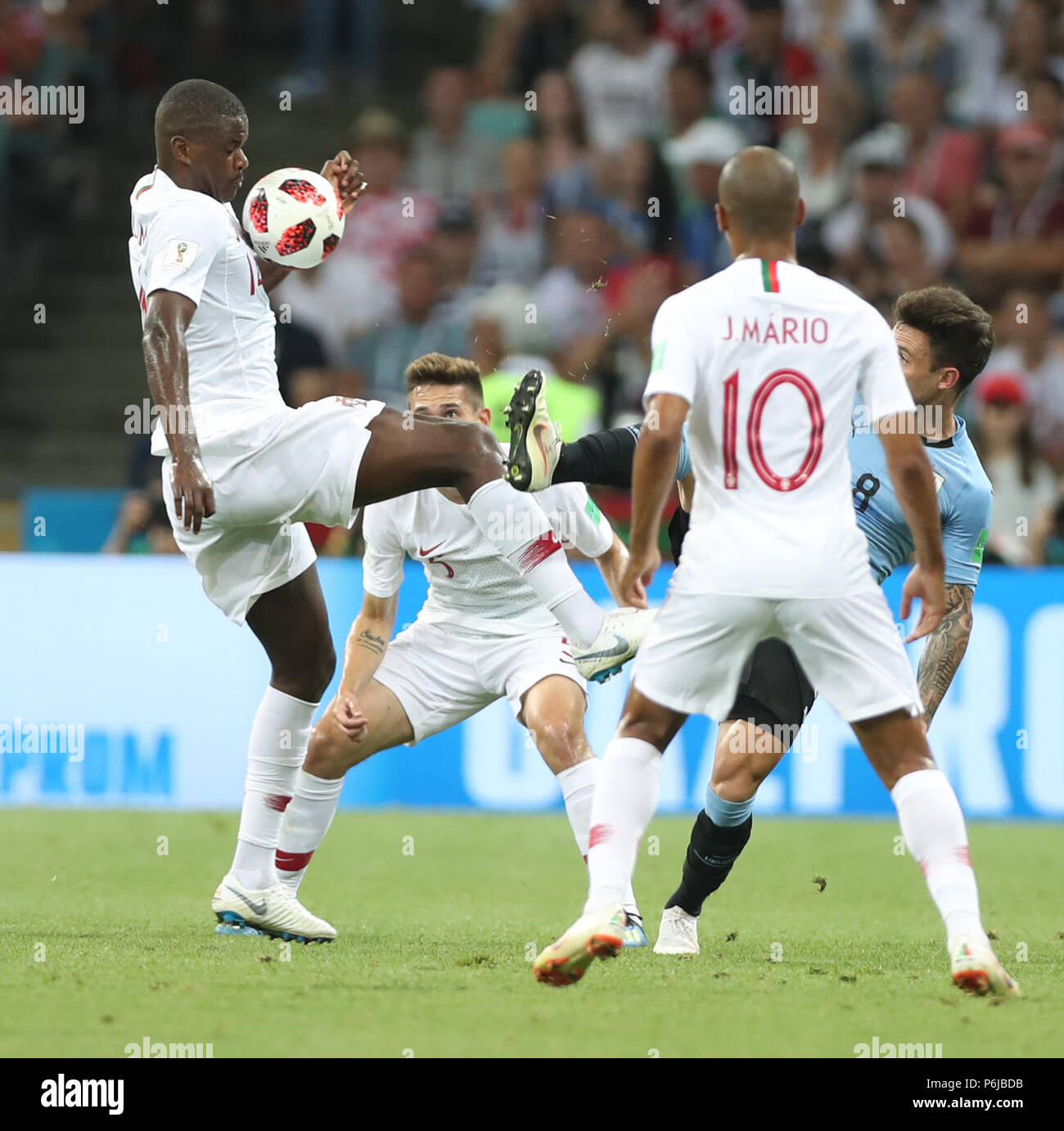 Sochi, Russia. 30th June, 2018. William Carvalho (1st L) of Portugal vies with Nahitan Nandez (1st R) of Uruguay during the 2018 FIFA World Cup round of 16 match between Uruguay and Portugal in Sochi, Russia, June 30, 2018. Credit: Fei Maohua/Xinhua/Alamy Live News Stock Photo