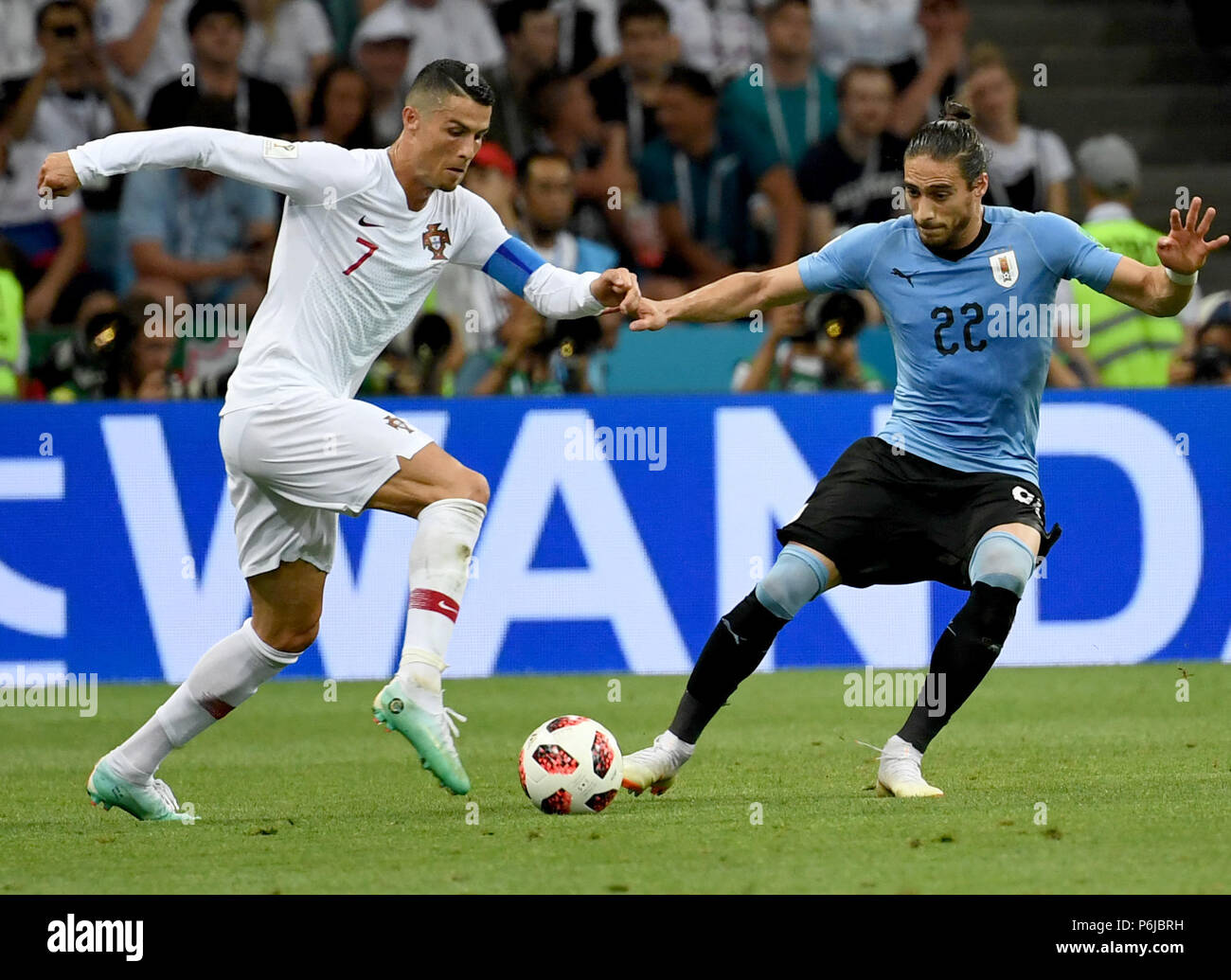 Sochi, Russia. 30th June, 2018. Cristiano Ronaldo (L) of Portugal vies with Martin Caceres of Uruguay during the 2018 FIFA World Cup round of 16 match between Uruguay and Portugal in Sochi, Russia, on June 30, 2018. Uruguay won 2-1 and advanced to the quarter-final. Credit: Chen Cheng/Xinhua/Alamy Live News Stock Photo