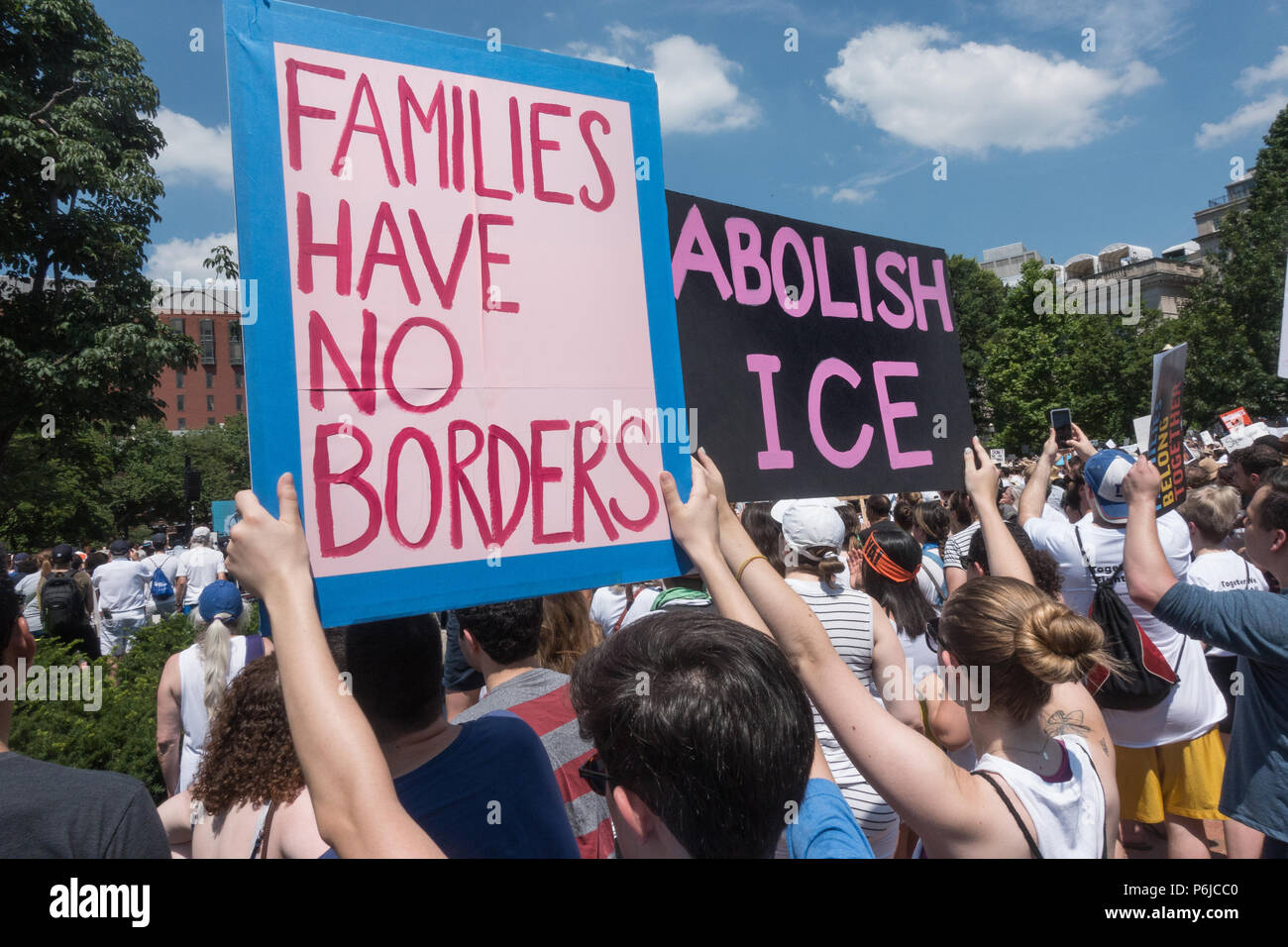 Washington, DC, USA.  30th June, 2018.  Some of the tens of thousands of participants in the Families Belong Together at rally in Lafayette Park in front of the White House, protesting the Trump administration’s vilification of immigrants, and zero-tolerance policy of automatically criminalizing undocumented immigrants, including those seeking asylum, which has included removing children from their parents at the Mexican border. A march to the Justice Department followed the rally. Credit: Bob Korn/Alamy Live News Stock Photo