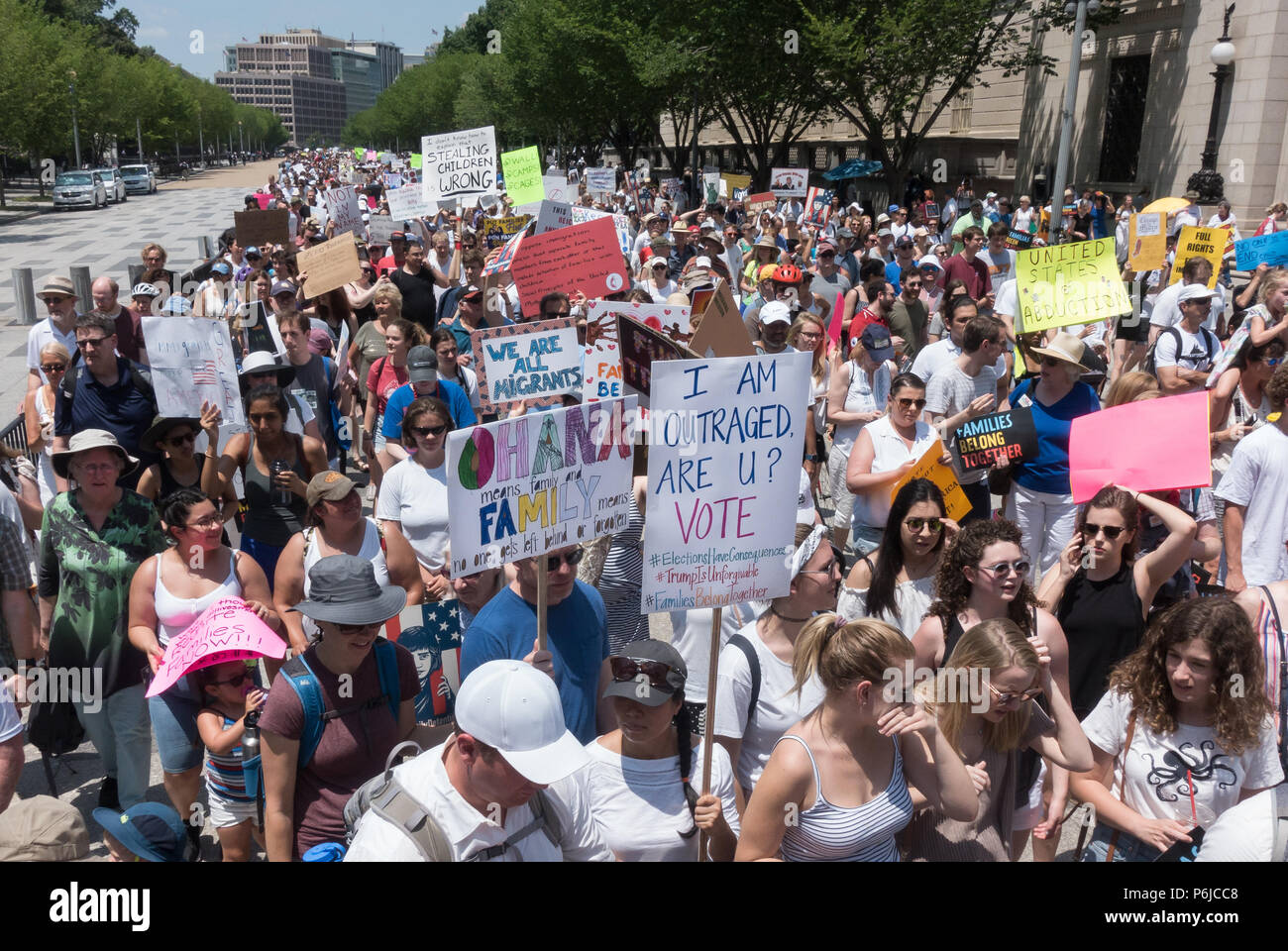 Washington, DC, USA.  30th June, 2018.  Some of the tens of thousands of participants in the Families Belong Together protest marching to the Justice Department from rally in Lafayette Park in front of the White House, protesting the Trump administration’s vilification of immigrants, and zero-tolerance policy of automatically criminalizing undocumented immigrants, including those seeking asylum, which has included removing children from their parents at the Mexican border. Credit: Bob Korn/Alamy Live News Stock Photo