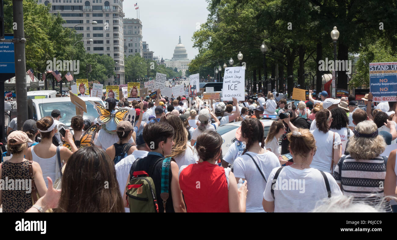 Washington, DC, USA.  30th June, 2018.  Some of the tens of thousands of participants in the Families Belong Together protest marching to the Justice Department from rally in Lafayette Park in front of the White House, protesting the Trump administration’s vilification of immigrants, and zero-tolerance policy of automatically criminalizing undocumented immigrants, including those seeking asylum, which has included removing children from their parents at the Mexican border. Credit: Bob Korn/Alamy Live News Stock Photo