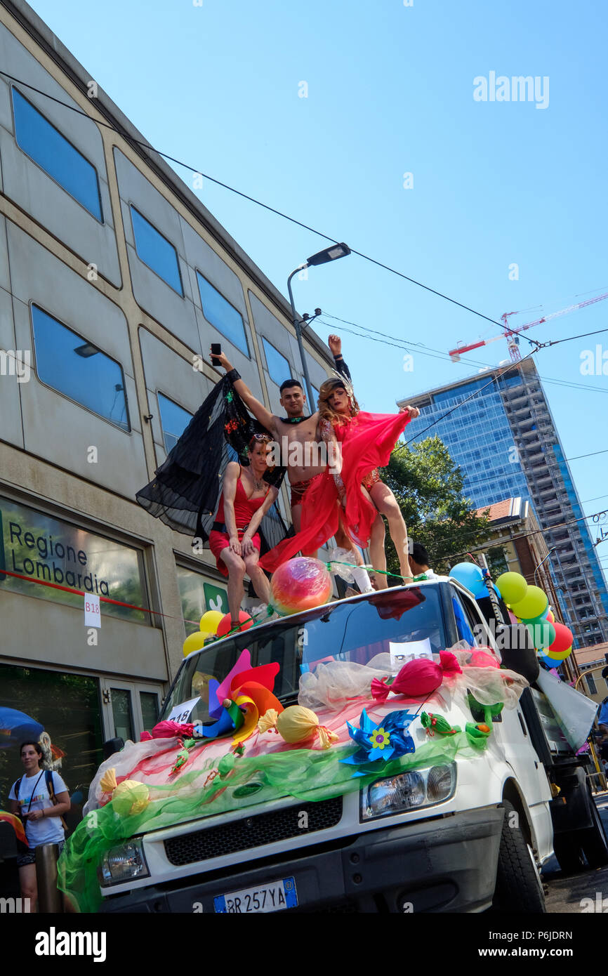 Milan, Italy. 30th Jun, 2018. Milano Pride 2018, manifestation of gay, lesbians, asexuals, bisexuals, intersexual and queer pride. Man and two transgenders dancing over a car. Milan, Italy. June 30, 2018. Credit: Gentian Polovina/Alamy Live News Stock Photo