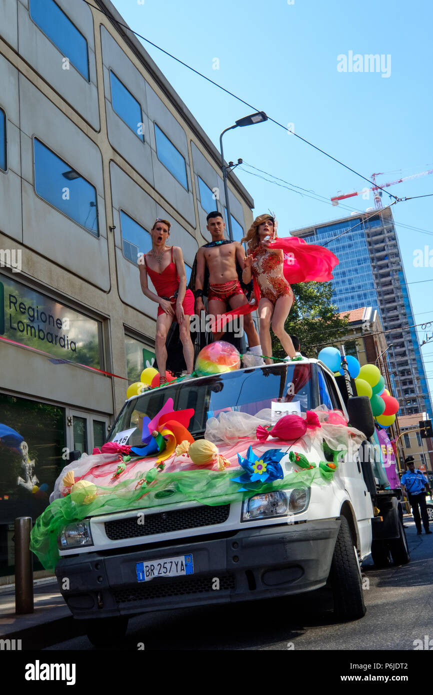 Milan, Italy. 30th Jun, 2018. Milano Pride 2018, manifestation of gay, lesbians, asexuals, bisexuals, intersexual and queer pride. Man and two transgenders dancing over a car. Milan, Italy. June 30, 2018. Credit: Gentian Polovina/Alamy Live News Stock Photo