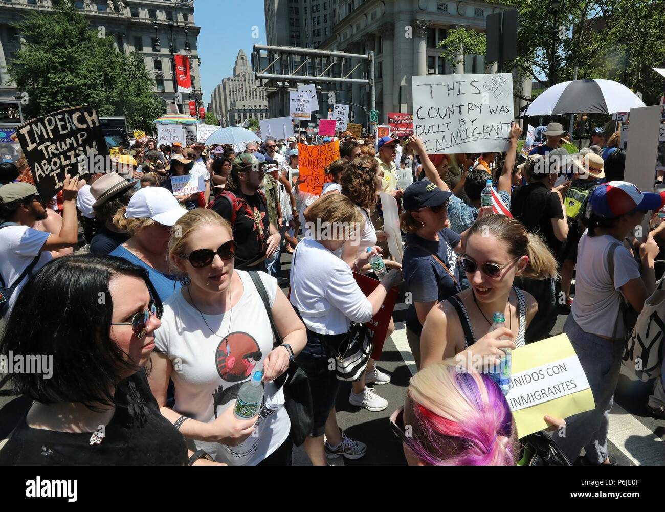 New York, USA. 30th June, 2018. People participate in the 'End Family Separation NYC' rally at downtown Manhattan in New York, the United States, on June 30, 2018. Tens of thousands of Americans marched and rallied across the United States to protest the Trump administration's 'zero tolerance' immigration policy resulting in over 2,000 children separated from their families who crossed the border illegally. Credit: Zhou Sa'ang/Xinhua/Alamy Live News Stock Photo