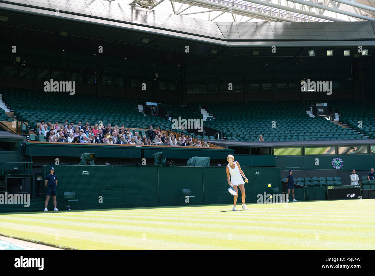 London, UK. 30 June 2018.  The Wimbledon Tennis Championships 2018 held at The All England Lawn Tennis and Croquet Club, London, England, UK.    Practice Saturday - General View - GV.  In an otherwise empty Centre Court, AELTC Members gather in the Royal Box to watch a Members' Doubles match.  This is to rehearse Royal Box procedures and tamp-down the Court. Credit: Duncan Grove/Alamy Live News Stock Photo
