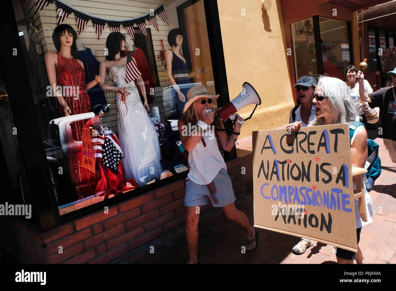 Nogales, Arizona, USA. 30th June, 2018. Families Belong Together hold protest march in Nogales, Arizona. It was one of hundreds demonstrations throughout the United States against the Trump administrations policy of separating children from their parents who are caught entering the U.S. illegally . Although the President has since reversed his original decision thousands of migrant children remain apart from their parents. Protestors marched through the border town of Nogales and ended up blocking traffic at the DeConcini port of entry for several hours. (Credit Image: © Christopher Brown via Stock Photo