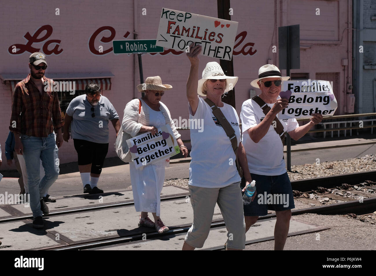 Nogales, Arizona, USA. 30th June, 2018. Families Belong Together hold protest march in Nogales, Arizona. It was one of hundreds demonstrations throughout the United States against the Trump administrations policy of separating children from their parents who are caught entering the U.S. illegally . Although the President has since reversed his original decision thousands of migrant children remain apart from their parents. Protestors marched through the border town of Nogales and ended up blocking traffic at the DeConcini port of entry for several hours. (Credit Image: © Christopher Brown via Stock Photo