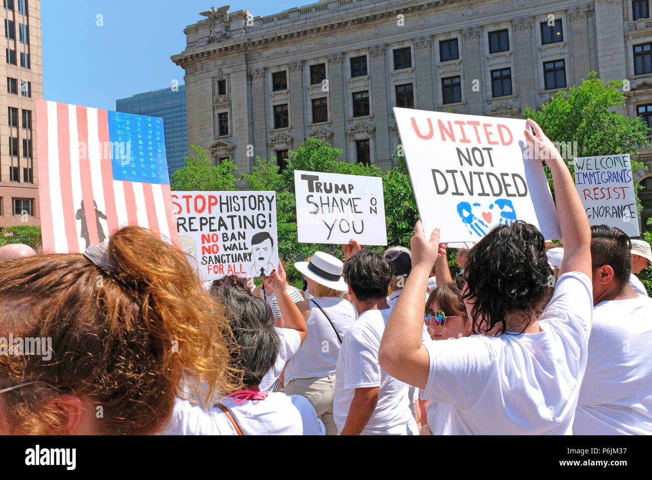 Cleveland, USA.  30th June, 2018.  Protesters hold signs in Cleveland Public Square opposing Trump administration policies separating children from parents at the border. Credit: Mark Kanning/Alamy Live News Stock Photo