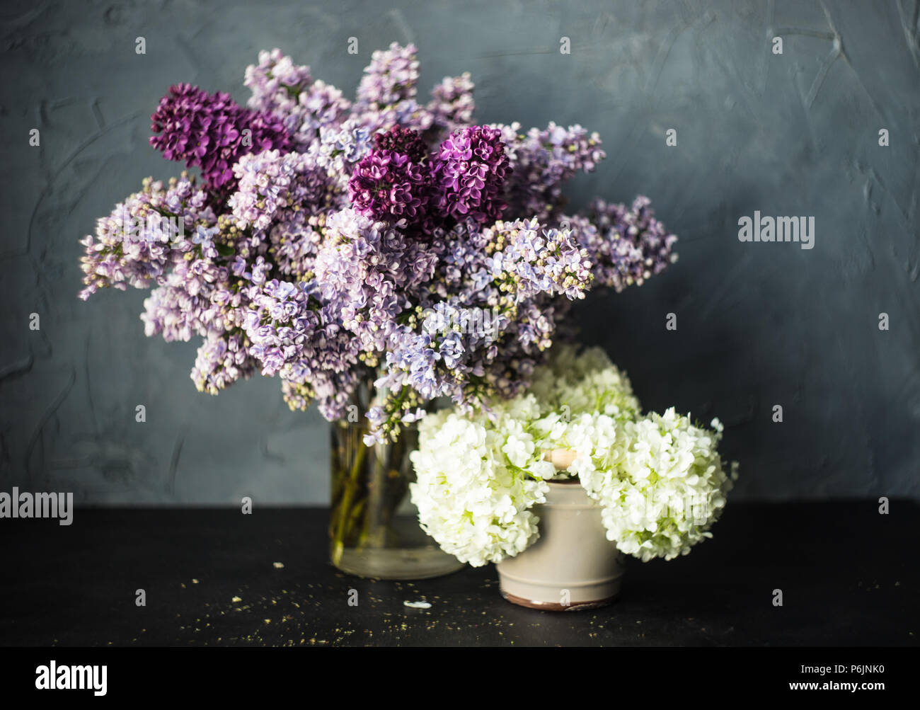 Lilac and Viburnum opulus 'Roseum' on a table with copy space Stock Photo