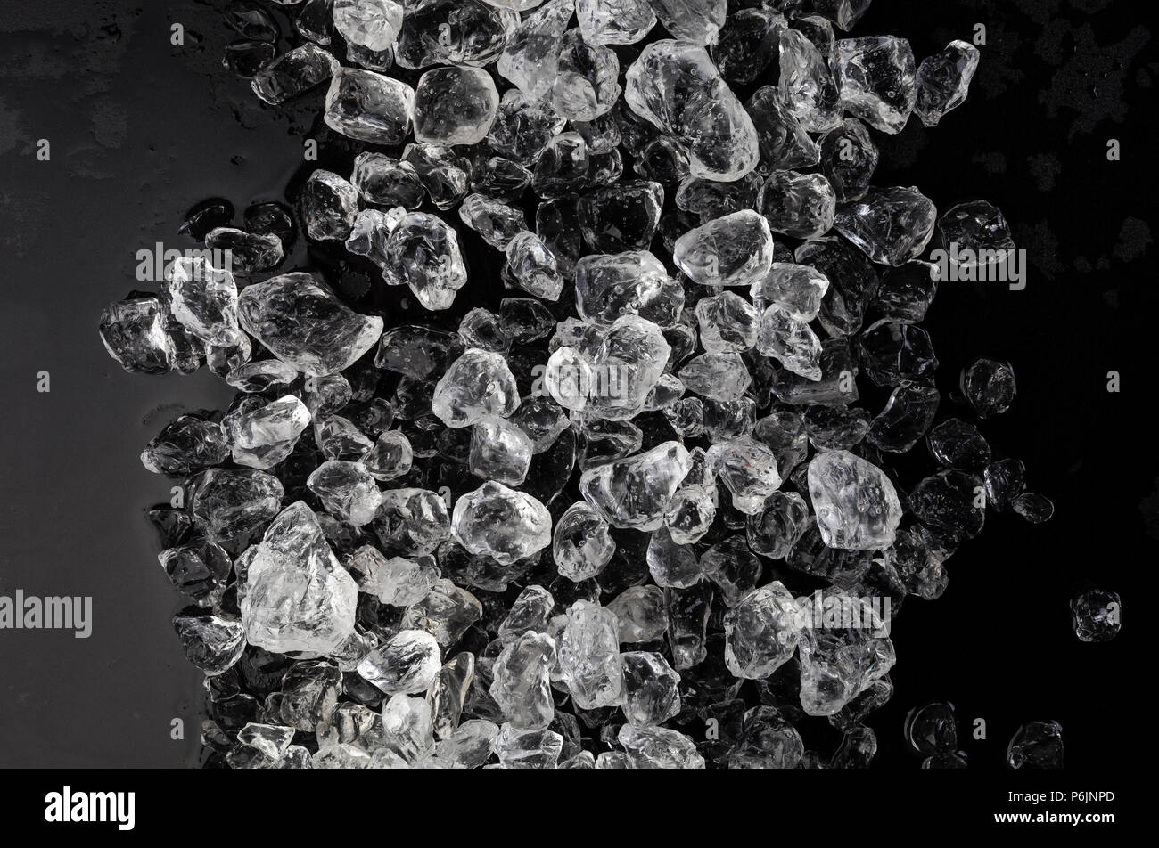 crushed ice cube texture on black background Stock Photo - Alamy