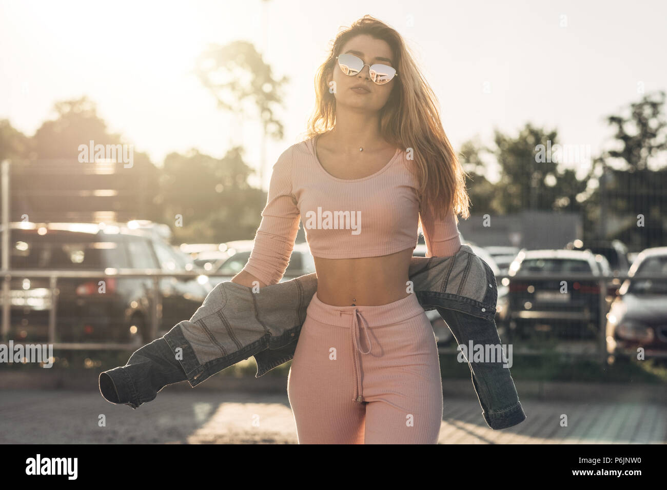 Portrait of Young and Beautiful Woman in Casual Clothes in the Street.  Dressed in Pink Shirt and Pants. Spring, Summer Concept. Relax Time. Girl  with Stock Photo - Alamy