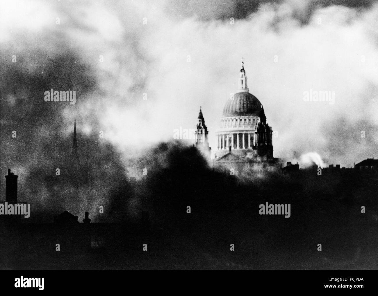 St. Paul's cathedral in London, surrounded by smoke and fires during the blitz by the German Luftwaffe in World War II in 1940. Stock Photo