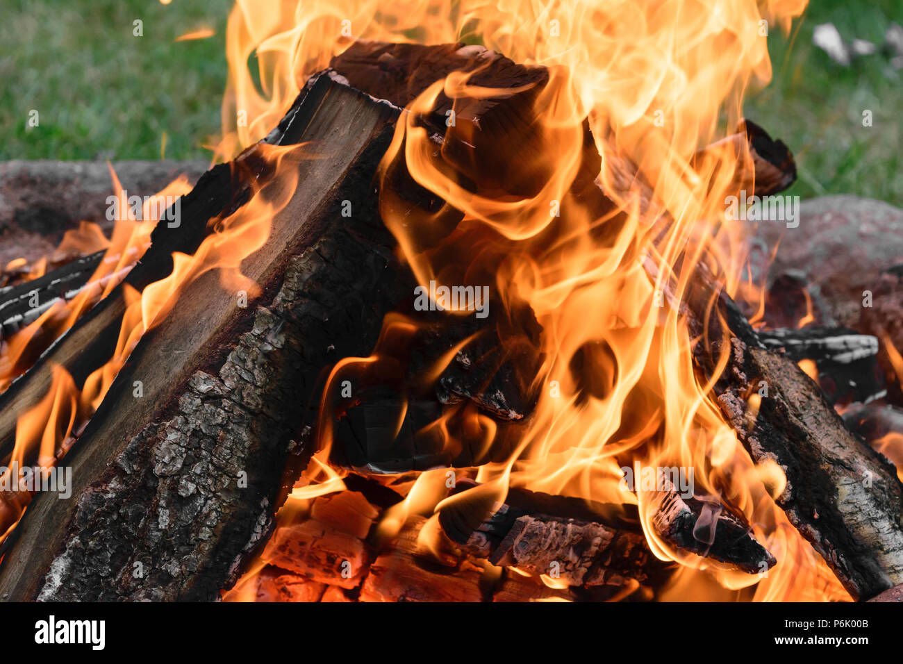 Burning bonfire with visible hot charcoal and ashes Stock Photo