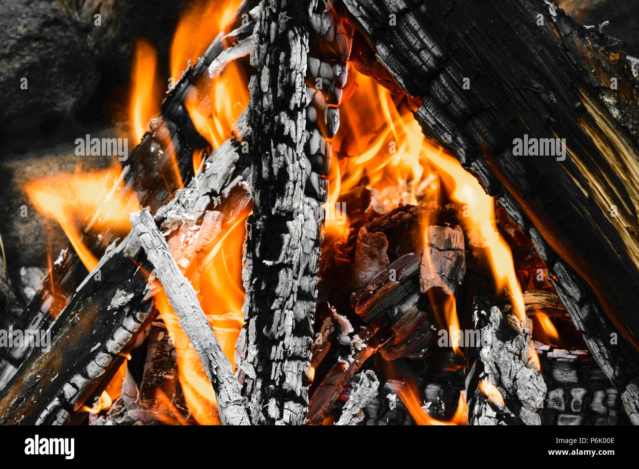 Burning bonfire with visible hot charcoal and ashes Stock Photo